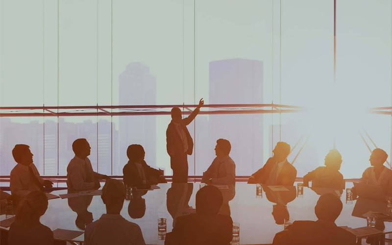 Best Coach - Business People In Conference Room In Front of Setting Sun